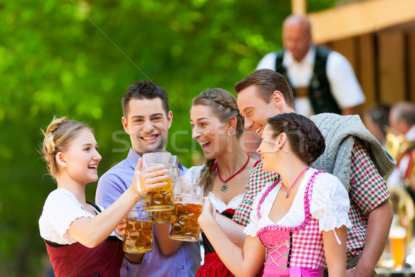 In Beer garden - friends in front of band Stock photo © Kzenon