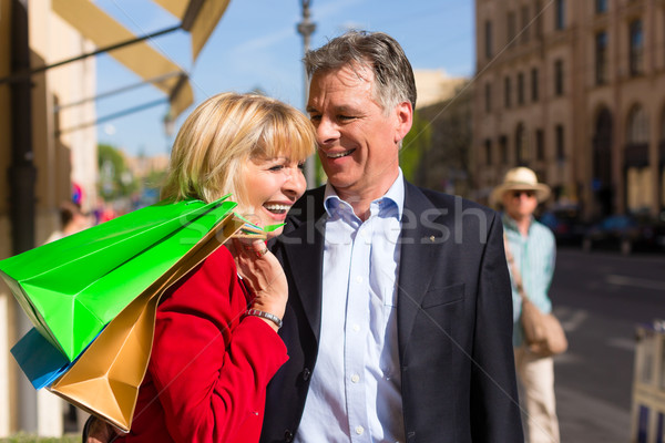 Mature couple strolling through city shopping in spring Stock photo © Kzenon