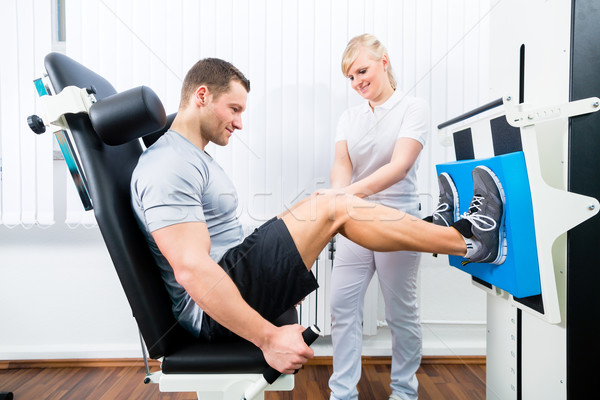 Physiotherapist exercising patient in sport therapy Stock photo © Kzenon