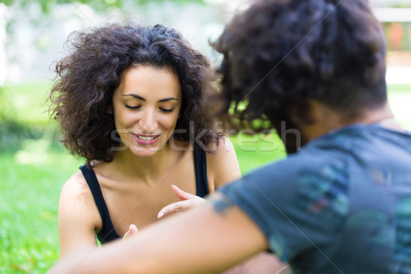 Latin couple on meadow with phone Stock photo © Kzenon