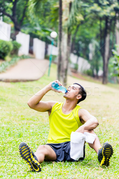 Stock photo: Asian man having break from sport training