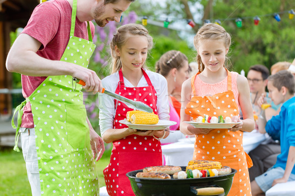 Family having barbeque at garden party  Stock photo © Kzenon