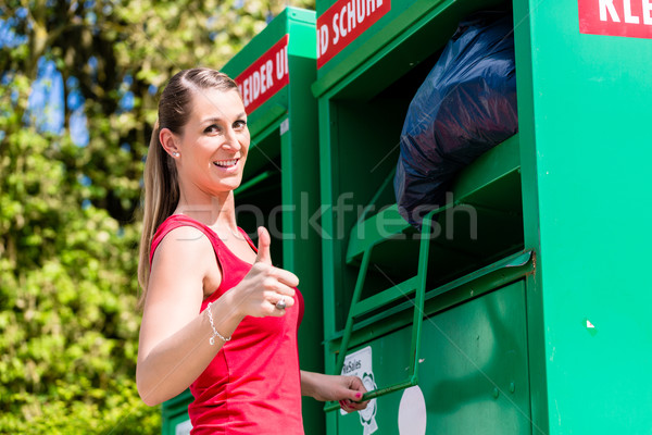 Woman at clothes recycling skip Stock photo © Kzenon