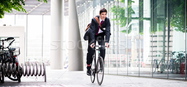 Derűs fiatal alkalmazott lovaglás hasznosság bicikli Stock fotó © Kzenon