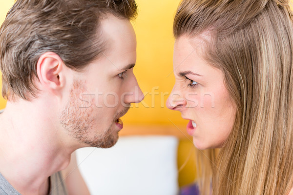 Young married couple, woman and man, in furious fight staring an Stock photo © Kzenon