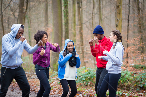 Determined young people warming up with boxing moves Stock photo © Kzenon
