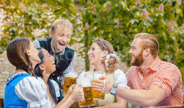 Friends drinking beer in beer garden  Stock photo © Kzenon