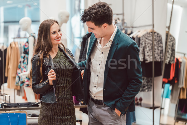 Woman showing her man new leather jacket in store Stock photo © Kzenon