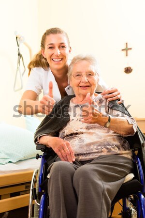 Young nurse and female senior in nursing home Stock photo © Kzenon
