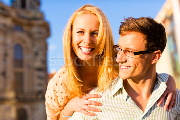 Woman jumping on the back of a man piggyback being happy Stock photo © Kzenon