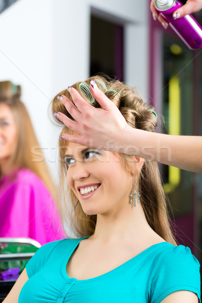 Women at the hairdresser being curled Stock photo © Kzenon