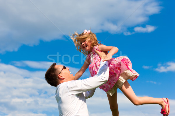 Family affairs - father and daughter playing in summer Stock photo © Kzenon