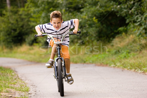Boy riding bicycle Stock photo © Kzenon
