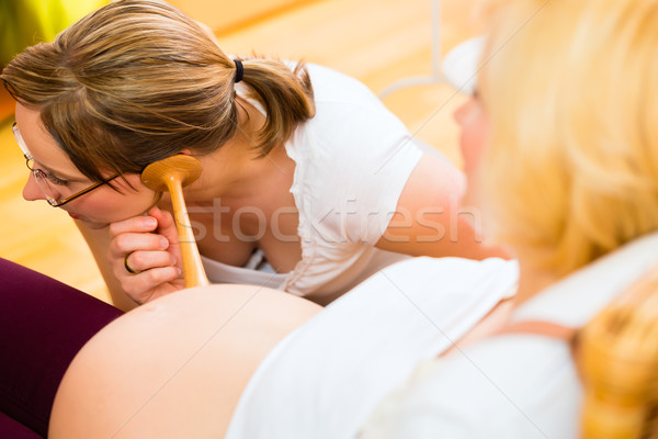 Midwife seeing mother for pregnancy examination Stock photo © Kzenon