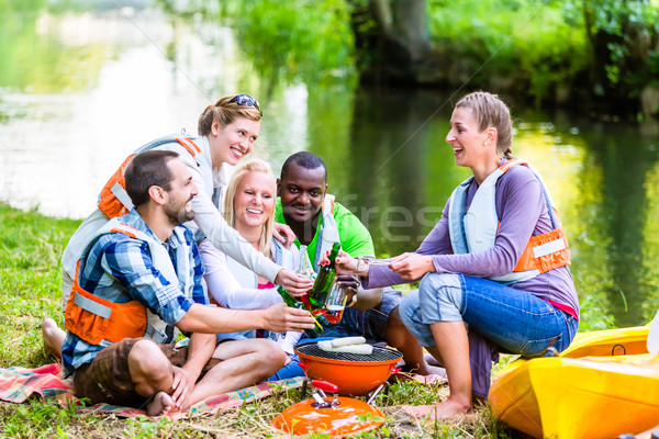 Friends barbecue after sports in forest drinking beer Stock photo © Kzenon