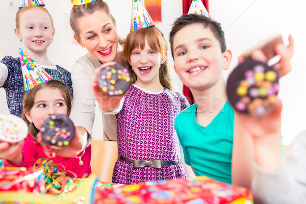 Kids showing muffin cakes at birthday party Stock photo © Kzenon