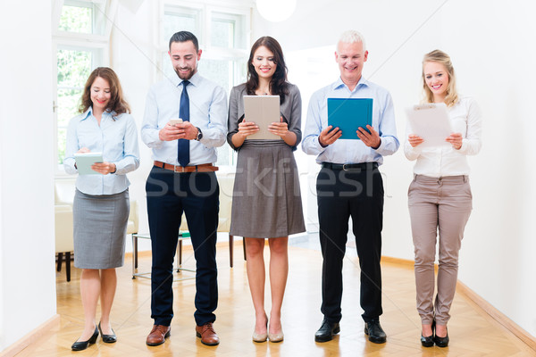 Concept - business people in office standing in row Stock photo © Kzenon