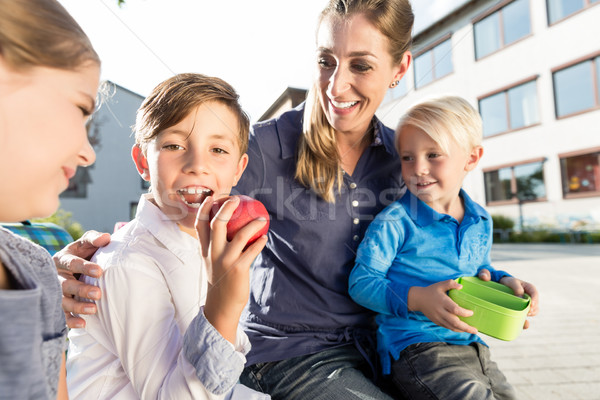 Mother and kids at school having breaktime with apple and lunchb Stock photo © Kzenon