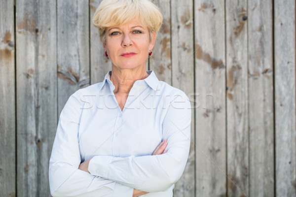 Portrait of a confident senior woman looking at camera against a Stock photo © Kzenon