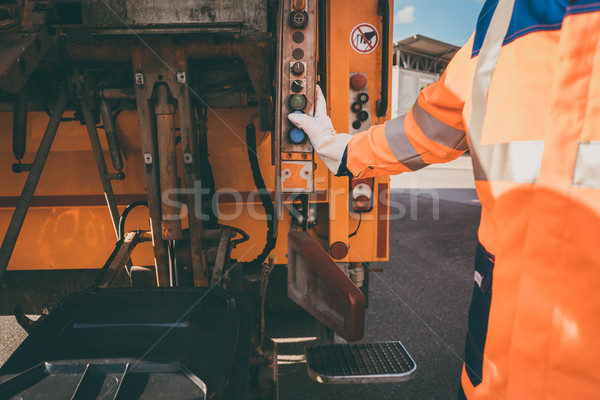 Worker emptying dustbin into waste vehicle Stock photo © Kzenon