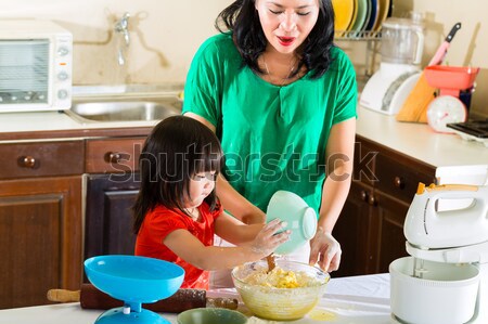 Stock photo: Asian Mother and daughter at home in kitchen