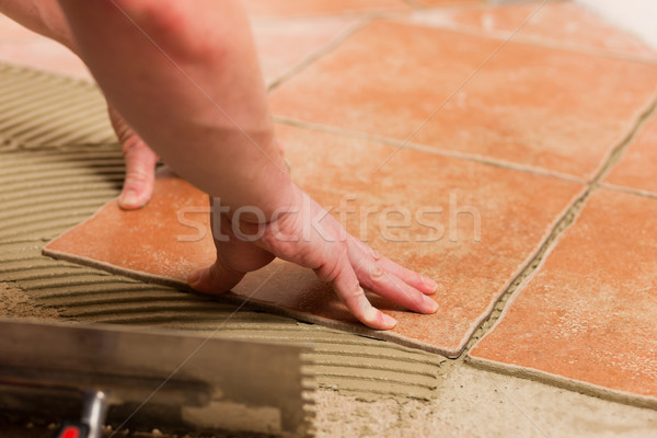 Tiler tiling tiles on the floor Stock photo © Kzenon