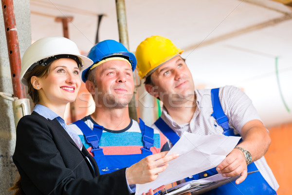 Work Team on construction site controlling floor plan Stock photo © Kzenon