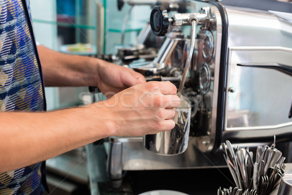 Barista in cafe or coffee bar preparing cappuccino Stock photo © Kzenon