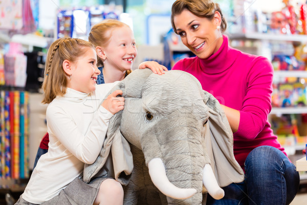 family in toy store cuddling with stuffed animal Stock photo © Kzenon