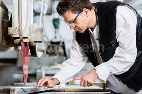 Handyman in stone carving factory at diamond saw Stock photo © Kzenon