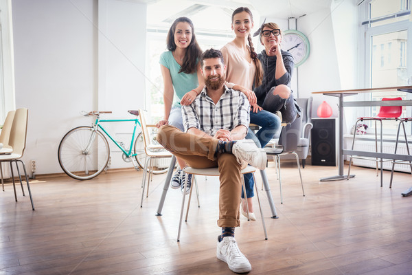 four co-workers wearing casual clothes during work in a modern h Stock photo © Kzenon