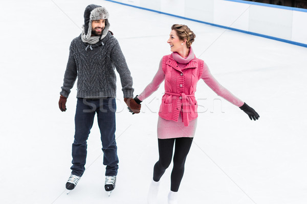 Couple patinage hiver heureux main Photo stock © Kzenon