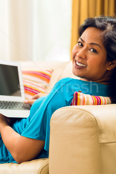 Asian femme séance canapé surf internet [[stock_photo]] © Kzenon