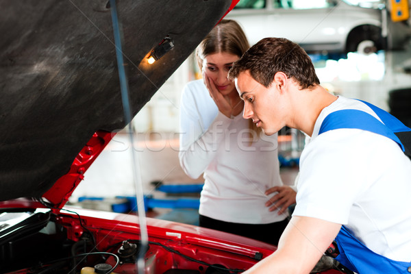 Woman talking to car mechanic in repair shop Stock photo © Kzenon