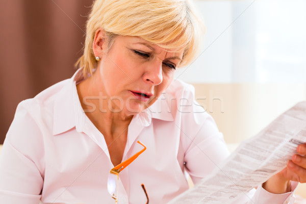Senior reading with presbyopia package insert Stock photo © Kzenon