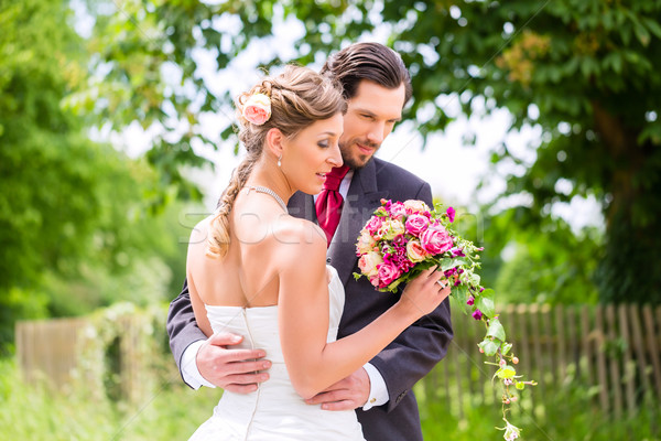 Wedding bride and groom with bridal bouquet Stock photo © Kzenon