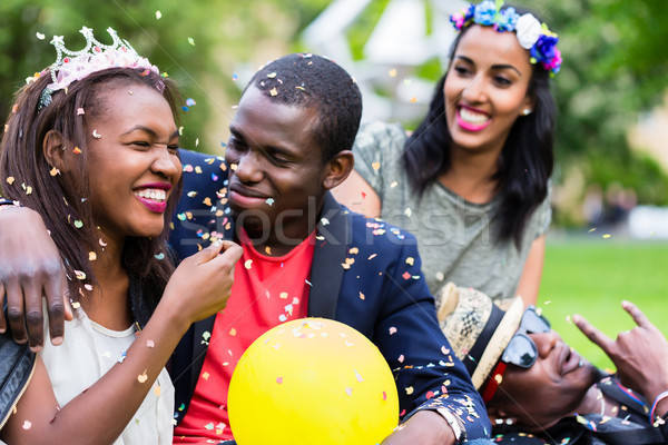 Indian girl and african couple celebrating together on street pa Stock photo © Kzenon