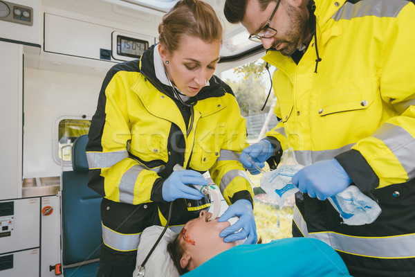 Emergency medics performing reanimation on clinically dead woman Stock photo © Kzenon