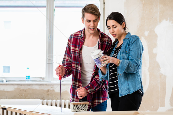 Stock photo: Portrait of a happy young couple holding tools for home remodeling