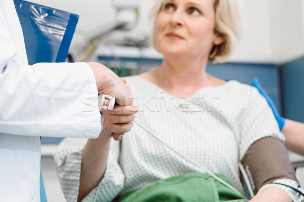Doctor shaking hands of patient recovering after operation Stock photo © Kzenon