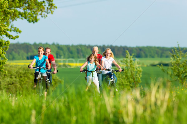 Family cycling outdoors in summer Stock photo © Kzenon