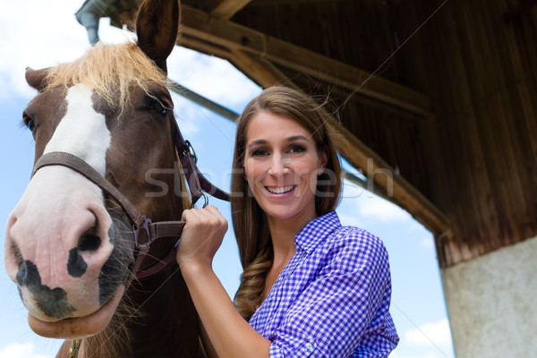 Stock photo: Young woman in the stable with horse at sunshine