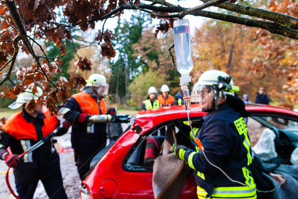 Accident - Fire brigade rescues Victim of a car crash Stock photo © Kzenon