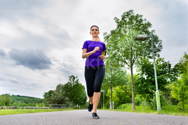 Sports outdoor - young woman running in park Stock photo © Kzenon