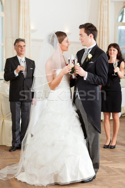 Bridal couple clinking glasses Stock photo © Kzenon