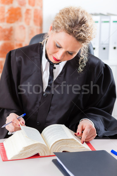 Lawyer in office reading law book Stock photo © Kzenon