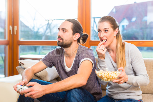 Couple video gaming and having popcorn Stock photo © Kzenon