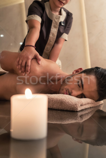 Young man enjoying the healing benefits of traditional Thai mass Stock photo © Kzenon