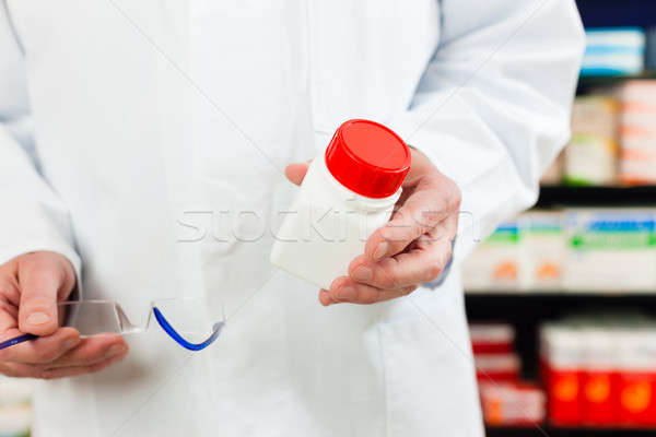 Pharmacist in pharmacy with medicament Stock photo © Kzenon