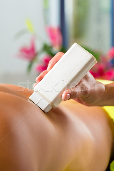 Man in Spa getting back waxed for hair removal Stock photo © Kzenon